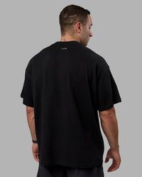 Man wearing Unisex Enjoy The Journey Heavyweight Tee Oversize - Black-Multi | Thumbnail Index: 3