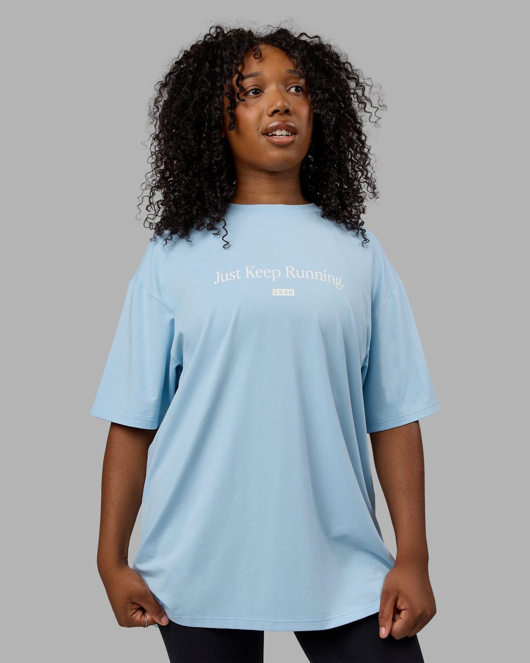 Woman wearing Unisex Just Keep Running FLXCotton Tee Oversize - Glacial Blue-Off White - view 5