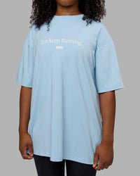 Woman wearing Unisex Just Keep Running FLXCotton Tee Oversize - Glacial Blue-Off White | Thumbnail Index: 7