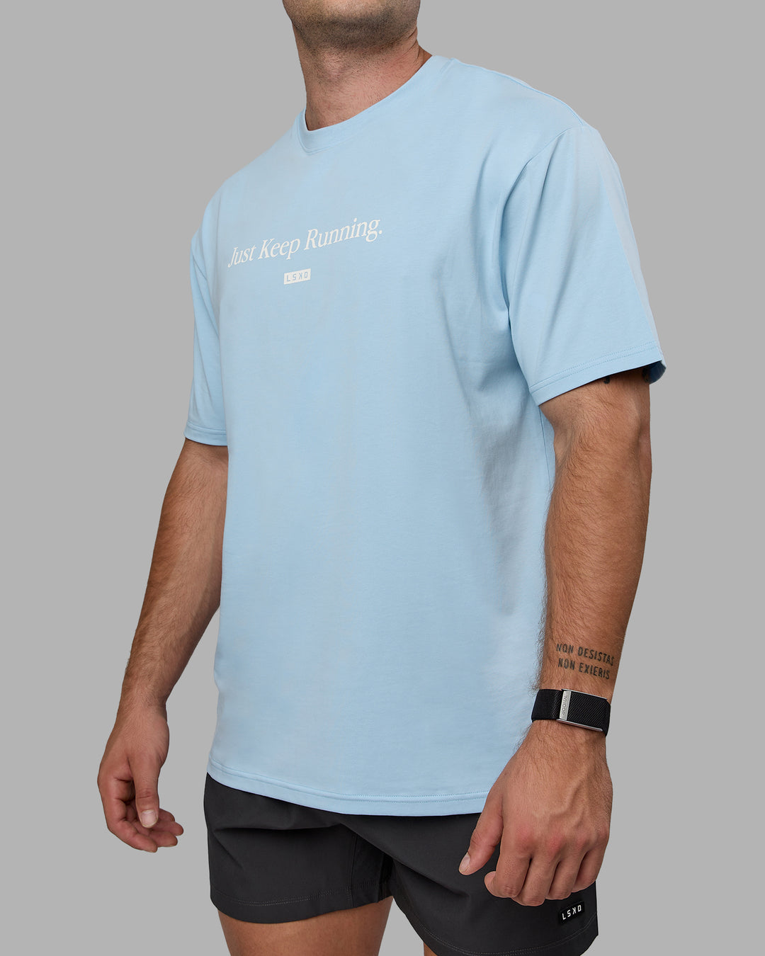 Man wearing Unisex Just Keep Running FLXCotton Tee Oversize - Glacial Blue-Off White - view 10