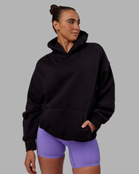 Woman wearing Unisex Keep on Running Hoodie Oversize - Black-White | Thumbnail Index: 2