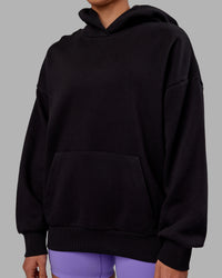 Woman wearing Unisex Keep on Running Hoodie Oversize - Black-White | Thumbnail Index: 7