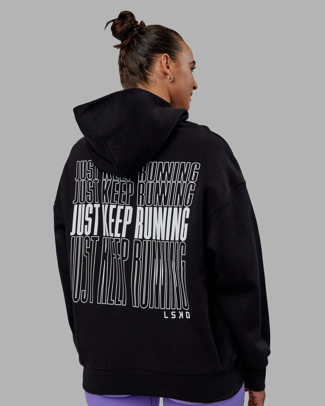 Woman wearing Unisex Keep on Running Hoodie Oversize - Black-White - view 7