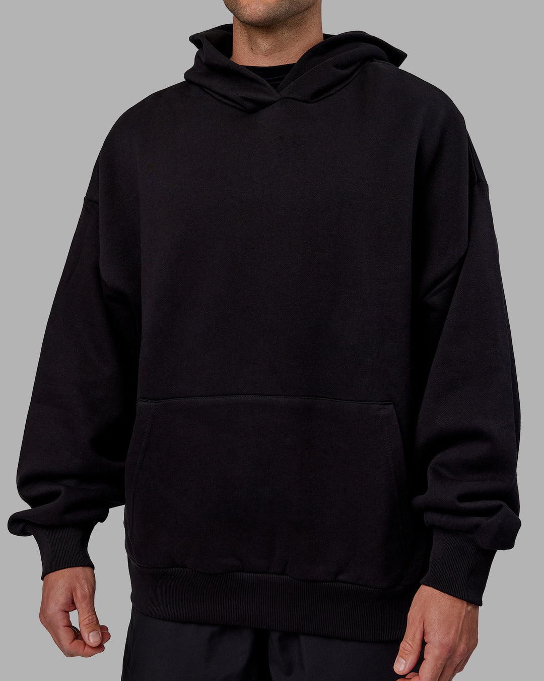 Man wearing Unisex Keep on Running Hoodie Oversize - Black-White - view 9