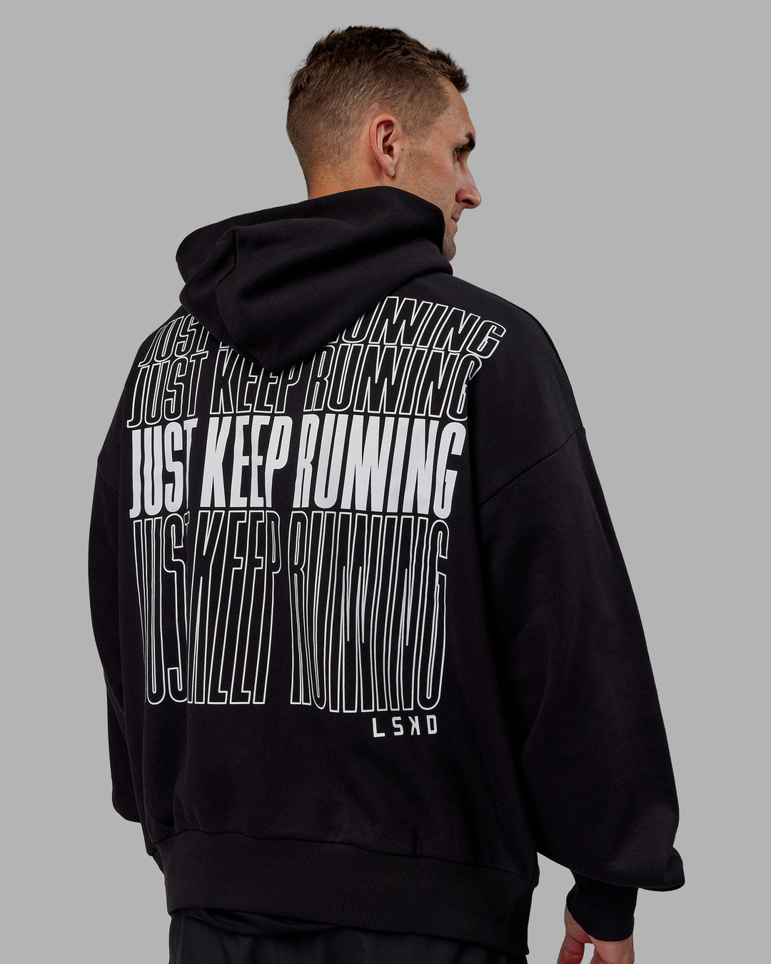 Man wearing Unisex Keep on Running Hoodie Oversize - Black-White - view 10