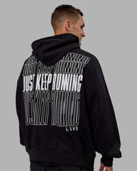 Man wearing Unisex Keep on Running Hoodie Oversize - Black-White | Thumbnail Index: 9