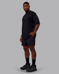 Man wearing Unisex Leg It FLXCotton Tee Oversize - Black-Volt | Thumbnail Index: 6