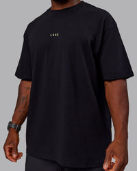Man wearing Unisex Leg It FLXCotton Tee Oversize - Black-Volt | Thumbnail Index: 9