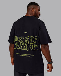 Man wearing Unisex Leg It FLXCotton Tee Oversize - Black-Volt | Thumbnail Index: 8