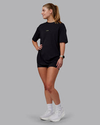 Woman wearing Unisex Leg It FLXCotton Tee Oversize - Black-Volt | Thumbnail Index: 7