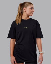 Woman wearing Unisex Leg It FLXCotton Tee Oversize - Black-Volt | Thumbnail Index: 5