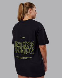 Woman wearing Unisex Leg It FLXCotton Tee Oversize - Black-Volt | Thumbnail Index: 1