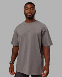 Man wearing Unisex Leg It FLXCotton Tee Oversize - Storm Front-Black | Thumbnail Index: 3