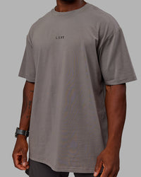 Man wearing Unisex Leg It FLXCotton Tee Oversize - Storm Front-Black | Thumbnail Index: 9