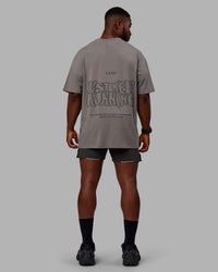 Man wearing Unisex Leg It FLXCotton Tee Oversize - Storm Front-Black | Thumbnail Index: 11