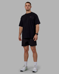 Man wearing Unisex Lift-Up FLXCotton Tee Oversize - Black-Fuschia Pink | Thumbnail Index: 4