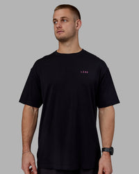 Man wearing Unisex Lift-Up FLXCotton Tee Oversize - Black-Fuschia Pink | Thumbnail Index: 2