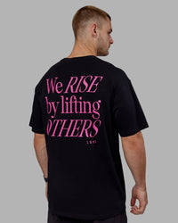 Man wearing Unisex Lift-Up FLXCotton Tee Oversize - Black-Fuschia Pink | Thumbnail Index: 6
