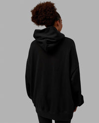 Woman wearing Unisex MVP Hoodie Oversize - Black | Thumbnail Index: 11