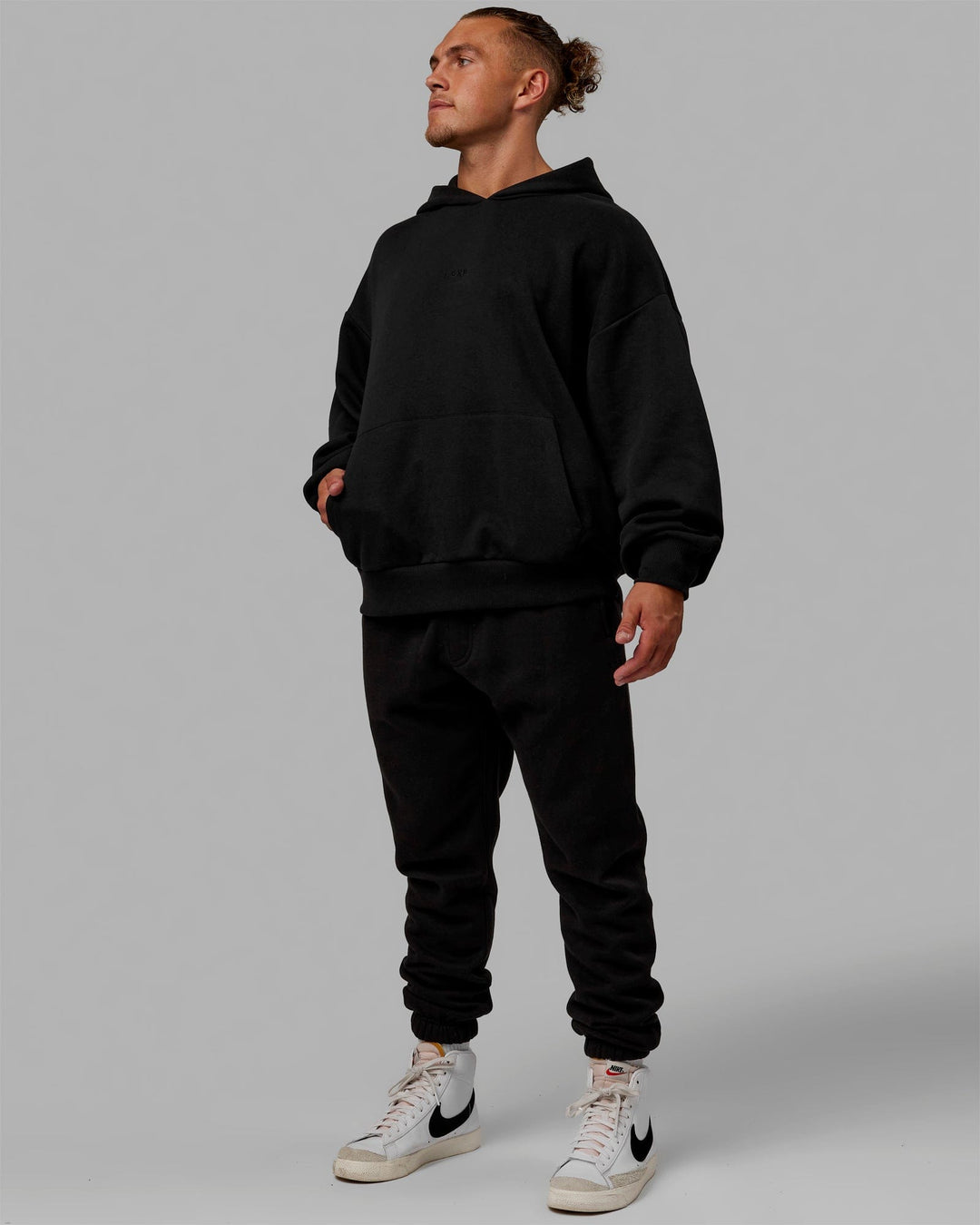 Man wearing Unisex MVP Hoodie Oversize - Black - view 9