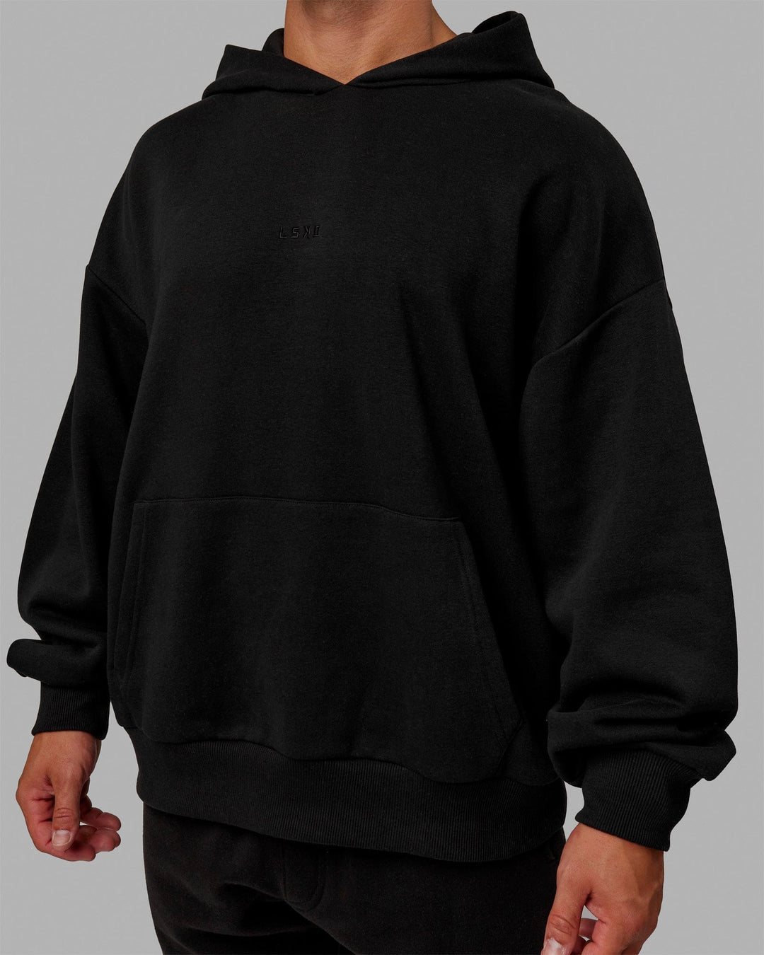 Man wearing Unisex MVP Hoodie Oversize - Black - view 10