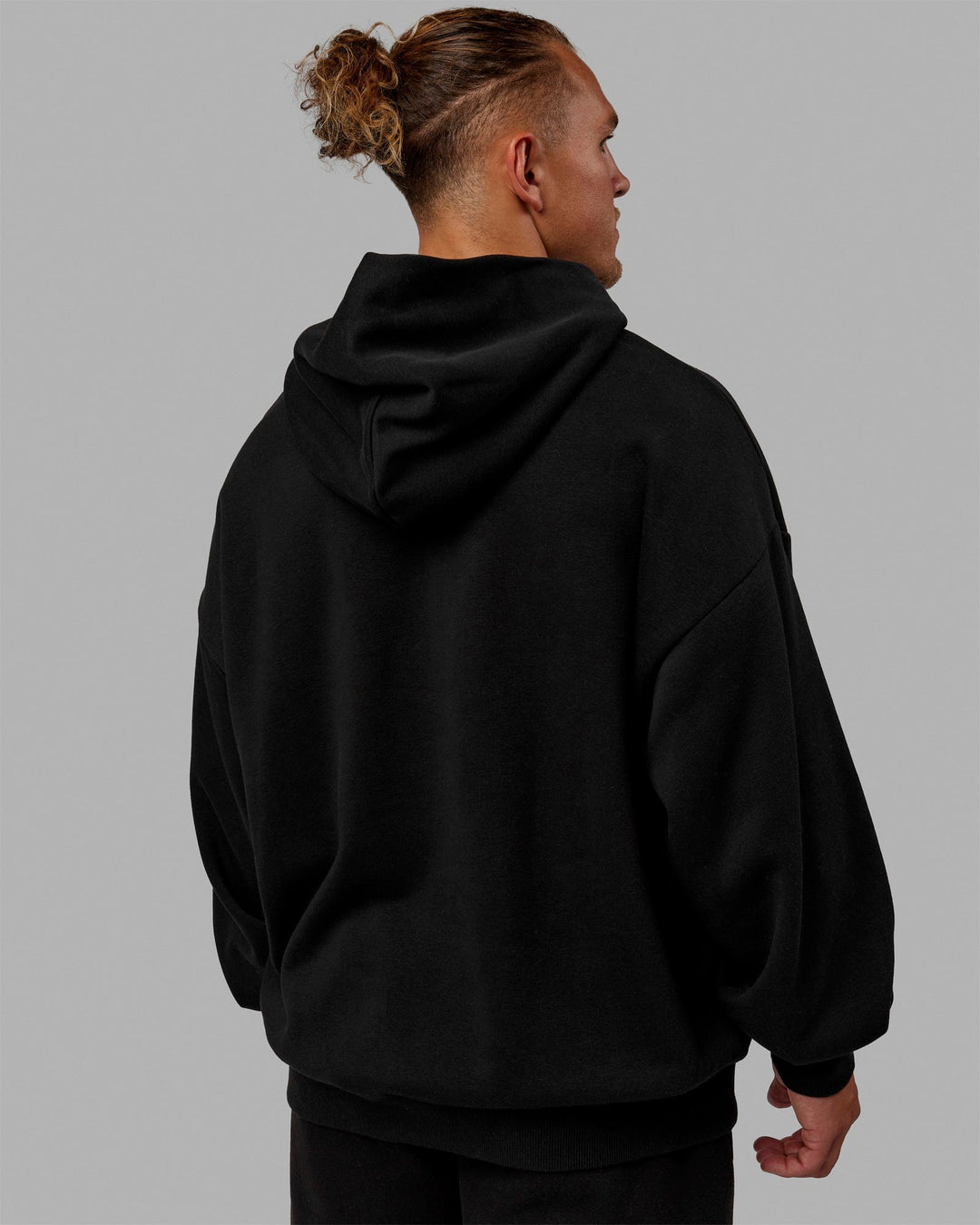 Man wearing Unisex MVP Hoodie Oversize - Black - view 5