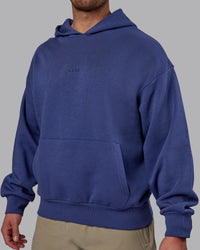 Man wearing Unisex MVP Hoodie Oversize - Future Dusk | Thumbnail Index: 8