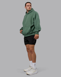 Man wearing Unisex MVP Hoodie Oversize - Sage Brush | Thumbnail Index: 8