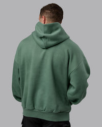Man wearing Unisex MVP Hoodie Oversize - Sage Brush | Thumbnail Index: 3