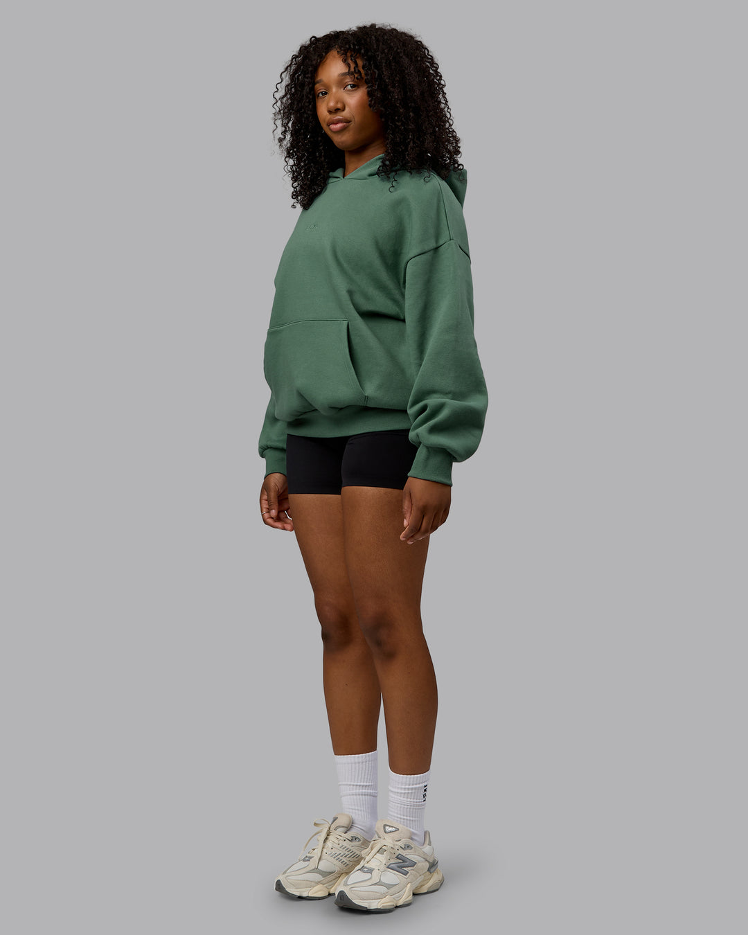 Woman wearing Unisex MVP Hoodie Oversize - Sage Brush - view 10