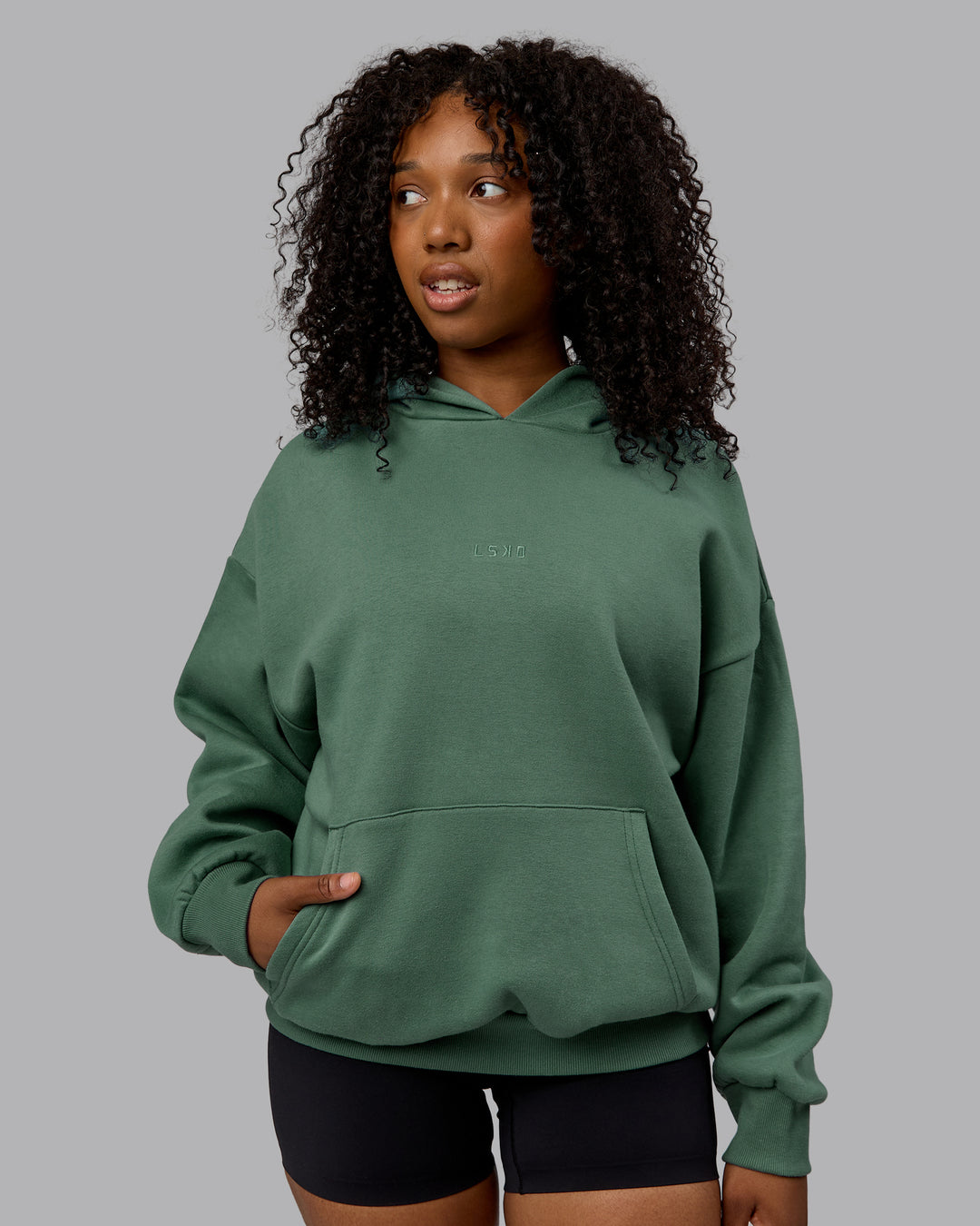 WOman wearing Unisex MVP Hoodie Oversize - Sage Brush - view 3