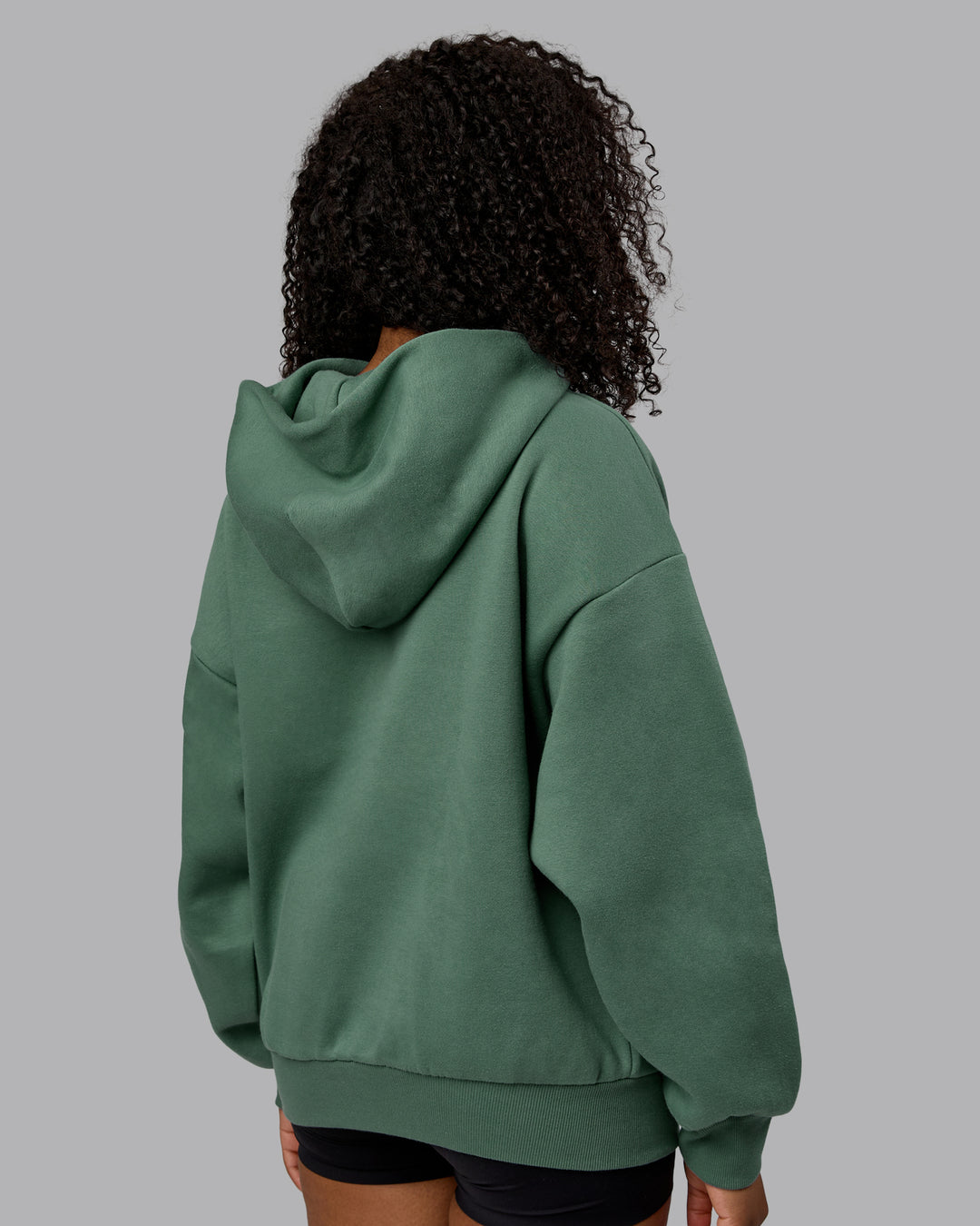 Woman wearing Unisex MVP Hoodie Oversize - Sage Brush - view 8