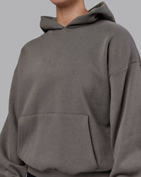 Woman wearing Unisex MVP Hoodie Oversize - Storm Front | Thumbnail Index: 8