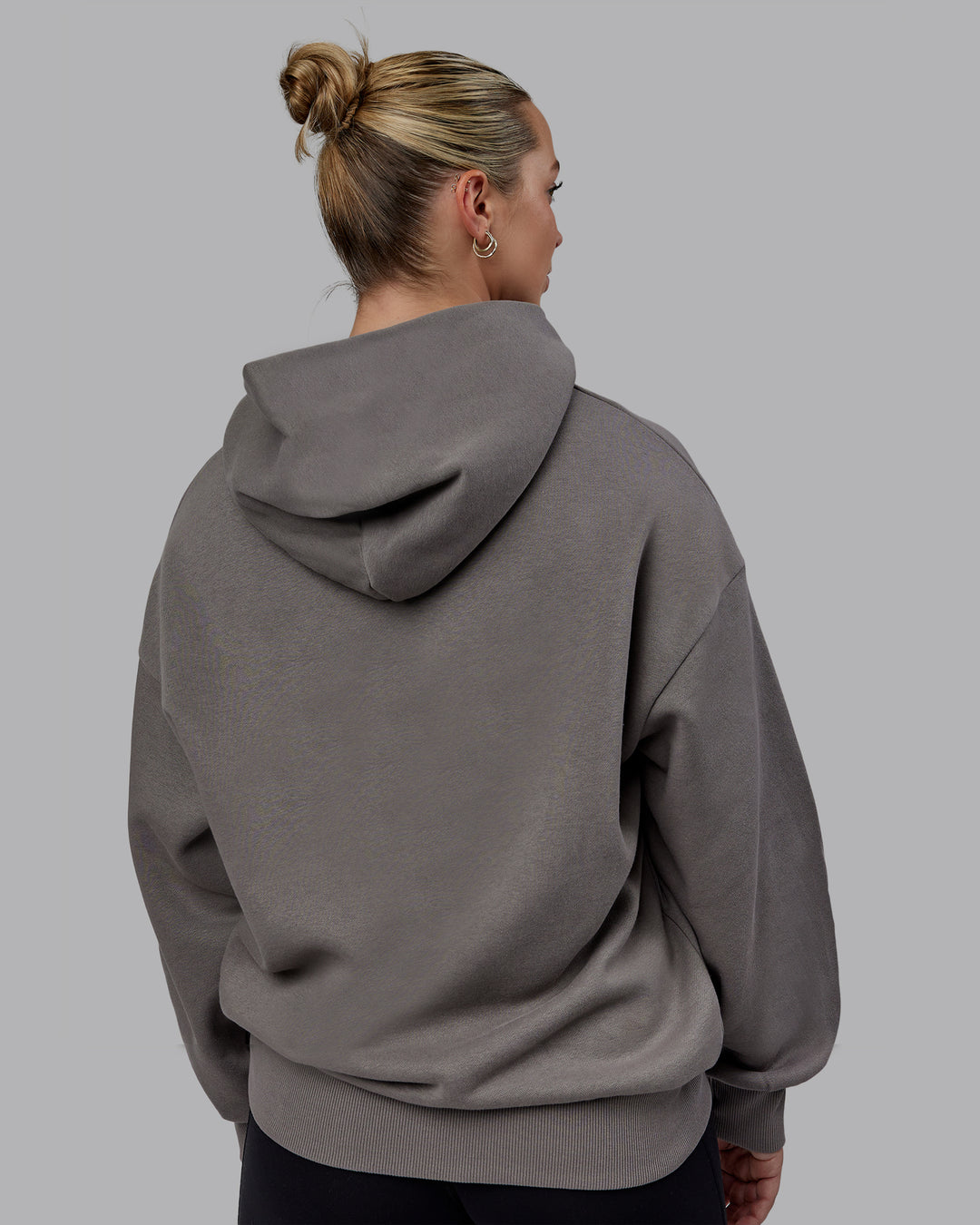 Woman wearing Unisex MVP Hoodie Oversize - Storm Front - view 11