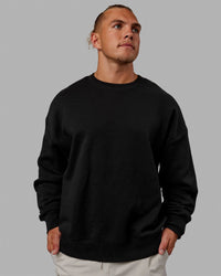 Man wearing Unisex MVP Sweater Oversize - Black | Thumbnail Index: 7