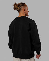 Man wearing Unisex MVP Sweater Oversize - Black | Thumbnail Index: 3