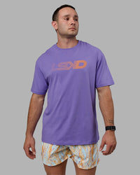 Man wearing Unisex Motion FLXCotton Tee Oversize - Dahlia Purple-Vibrant Orange | Thumbnail Index: 2