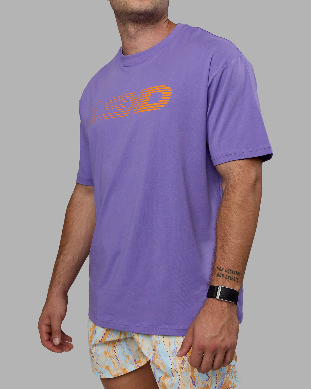 Man wearing Unisex Motion FLXCotton Tee Oversize - Dahlia Purple-Vibrant Orange - view 9