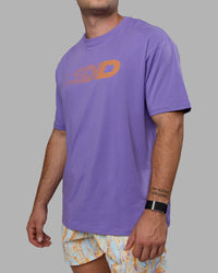 Man wearing Unisex Motion FLXCotton Tee Oversize - Dahlia Purple-Vibrant Orange | Thumbnail Index: 8