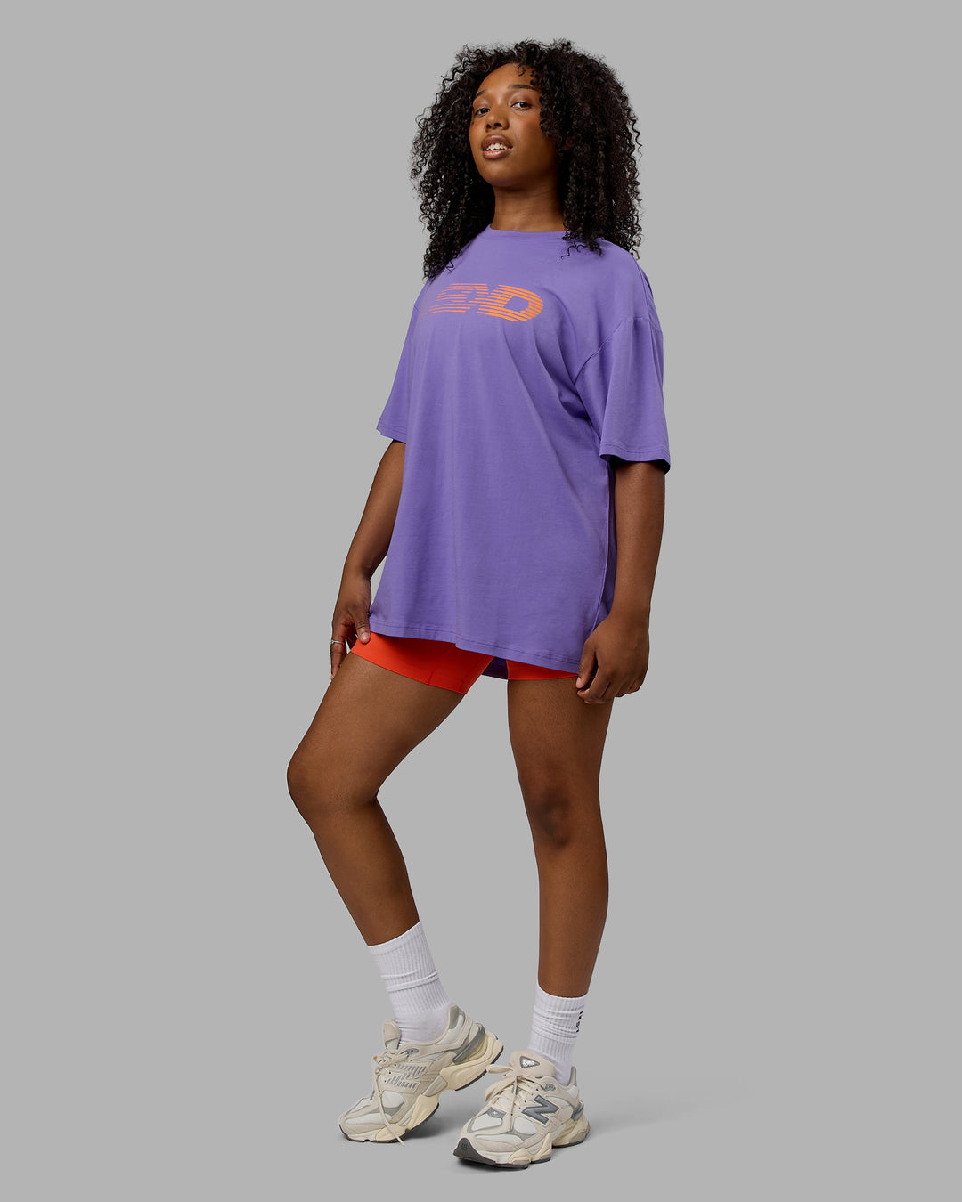 Woman wearing Unisex Motion FLXCotton Tee Oversize - Dahlia Purple-Vibrant Orange - view 5