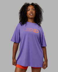 Woman wearing Unisex Motion FLXCotton Tee Oversize - Dahlia Purple-Vibrant Orange | Thumbnail Index: 1