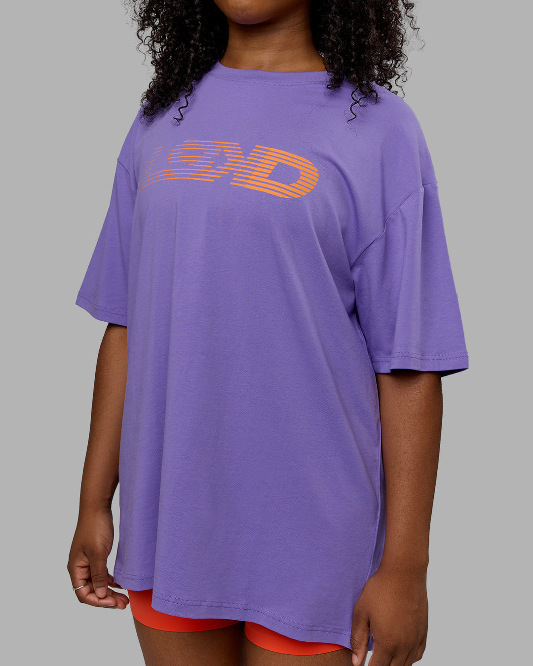 Woman wearing Unisex Motion FLXCotton Tee Oversize - Dahlia Purple-Vibrant Orange - view 7
