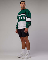 Man wearing Unisex PrimeTime Sweater Oversize - Malachite-White | Thumbnail Index: 5