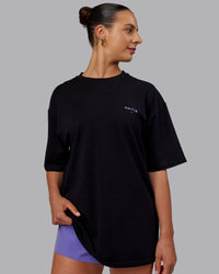 Woman wearing Unisex RUN CLUB FLXCotton Tee Oversize - Black-Purple Swirl | Thumbnail Index: 3