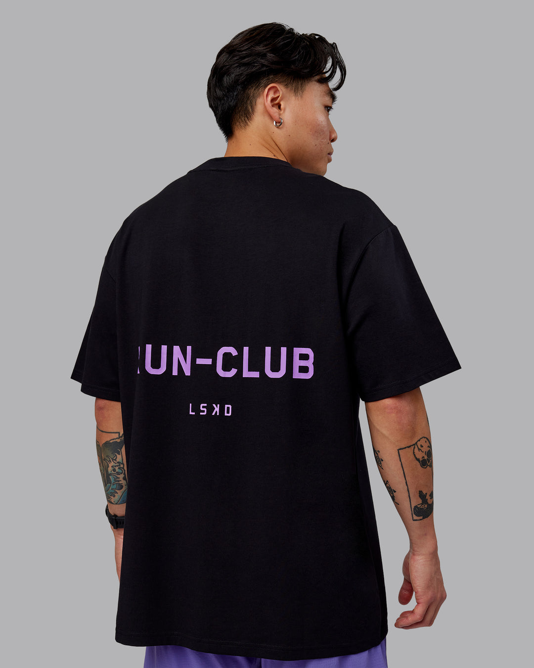 Man wearing Unisex RUN CLUB FLXCotton Tee Oversize - Black-Purple Swirl - view 7