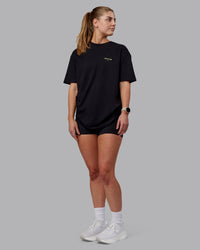 Woman wearing Unisex RUN CLUB FLXCotton Tee Oversize - Black-Vol | Thumbnail Index: 7
