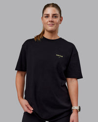 Woman wearing Unisex RUN CLUB FLXCotton Tee Oversize - Black-Vol | Thumbnail Index: 1