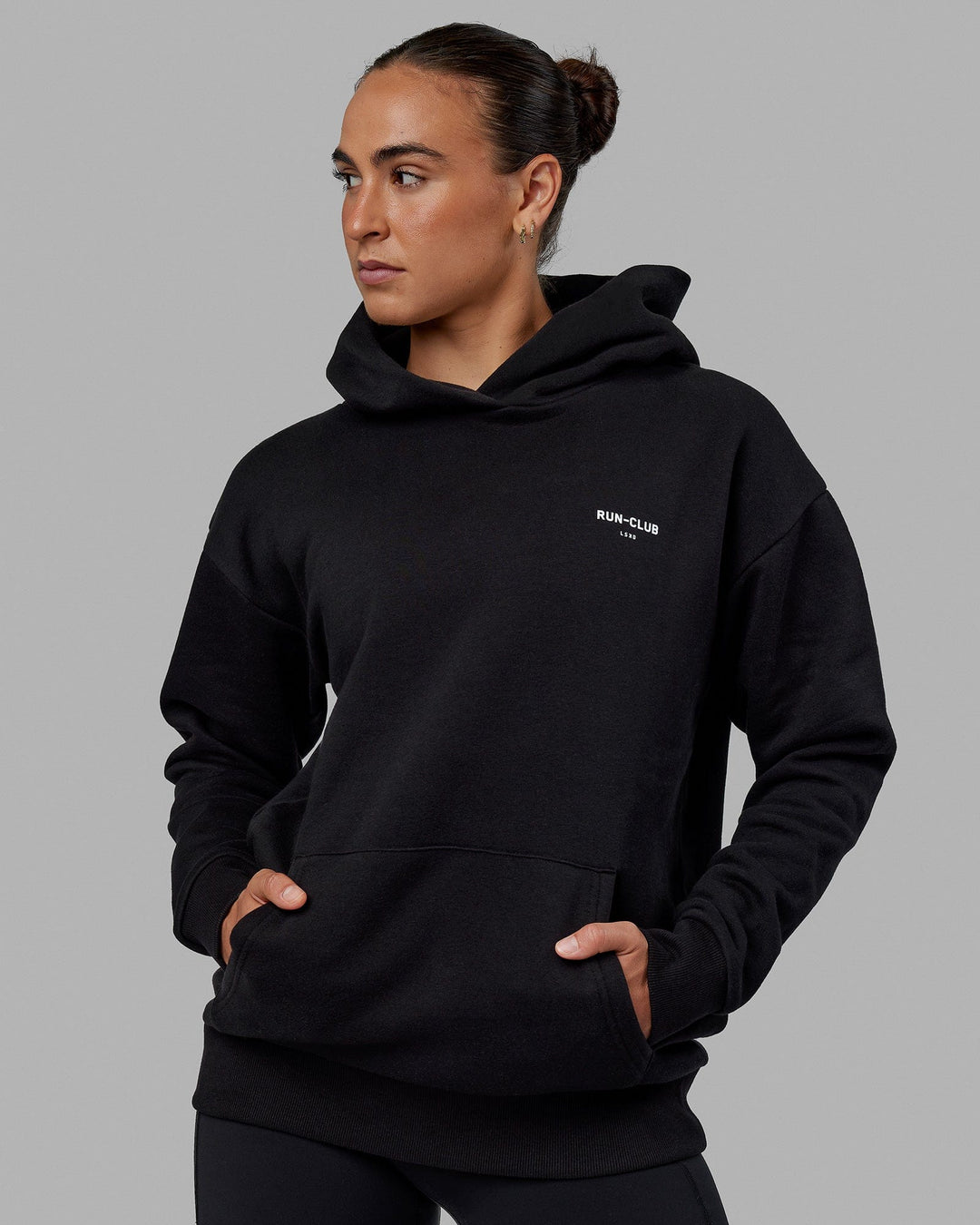 Woman wearing Unisex RUN-CLUB Hoodie Oversize - Black - view 6