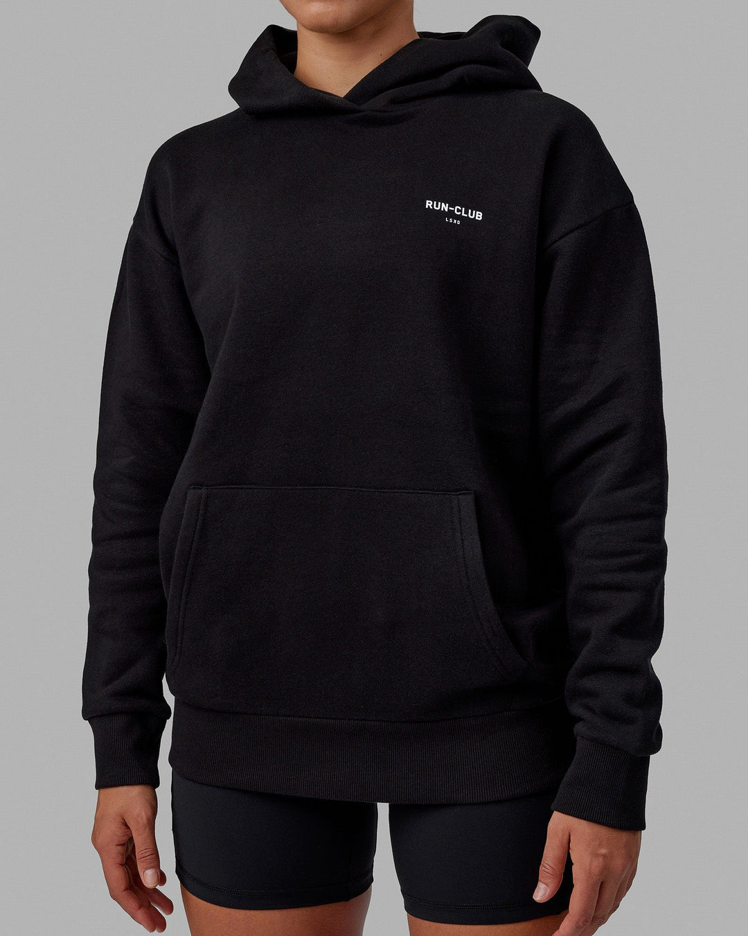 Woman wearing Unisex RUN-CLUB Hoodie Oversize - Black - view 9