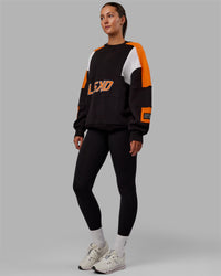 Woman wearing Unisex Slam Sweater Oversize - Black-Ultra Orange | Thumbnail Index: 4
